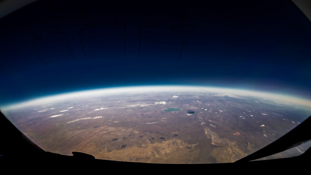 the horizon of the earth as seen from space. The horizon is clearly seen with its distinct curvature along the space continuum.